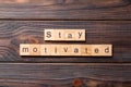 Stay motivated word written on wood block. Stay motivated text on cement table for your desing, concept Royalty Free Stock Photo