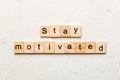 Stay motivated word written on wood block. Stay motivated text on cement table for your desing, concept Royalty Free Stock Photo