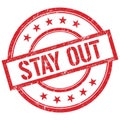 STAY OUT text written on red vintage stamp Royalty Free Stock Photo