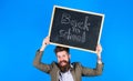Stay positive. Keep working and be kind to people. Teacher bearded man holds blackboard with inscription back to school