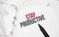 Stay Productive . Conceptual background with chart ,papers, pen and glasses Royalty Free Stock Photo