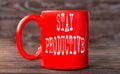 STAY PRODUCTIVE - word on a red cup on a dark background