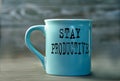 STAY PRODUCTIVE- words on a blue cup on a dark background Royalty Free Stock Photo