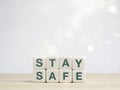 Stay safe concept. Green words, stay safe on white dice blocks.