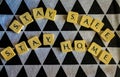 STAY SAFE STAY HOME - scrabble tiles against black and white textured background