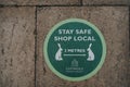 Stay Safe Shop Local and 2 metres social distancing sign on a street in Stow-on-the-Wold, Cotswolds, UK