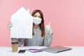 Stay safe, work at home. Woman employee sitting at workplace, wearing hygienic mask and protective gloves