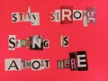 Stay strong spring is almost here written on scraps of magazine paper on a pink background Royalty Free Stock Photo