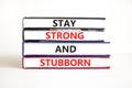 Stay strong and stubborn symbol. Concept words Stay strong and stubborn on books. Beautiful white table white background. Royalty Free Stock Photo