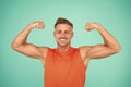 Stay strong in your life. Happy athlete show physical strength. Strong man flex arms blue background. Building strong