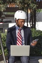 Stay in touch anywhere. Business man making a video call while working on laptop, sitting outdoors during the day Royalty Free Stock Photo