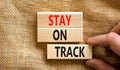 Stay on track symbol. Concept words Stay on track on wooden blocks on a beautiful canvas table canvas background. Businessman hand Royalty Free Stock Photo