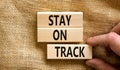 Stay on track symbol. Concept words Stay on track on wooden blocks on a beautiful canvas table canvas background. Businessman hand Royalty Free Stock Photo