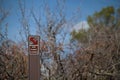 Stay on trail sign warning about plants Royalty Free Stock Photo