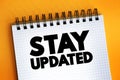 Stay Updated text on notepad, concept background Royalty Free Stock Photo