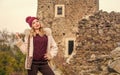 Stay warm and fashionable. Woman wear furry coat. Winter clothes. Wardrobe for cold weather. Girl stand near stone ruins