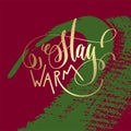 Stay warm - gold hand lettering on green and purple brush stroke
