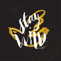 Stay Wild. Hand sketched bird logo. Gold cut silhouette on a black background. Hand drawn design elements. Vector illustration.