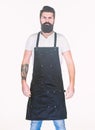 Staying clean and comfortable with chef apron. Bearded man cook in kitchen apron. Cook with long beard wearing bib apron