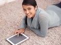 Staying connected has never been easier. An attractive young woman surfing the net on her digital tablet. Royalty Free Stock Photo