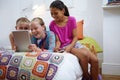 Staying entertained with technology. a group of teenage friends using a digital tablet together. Royalty Free Stock Photo