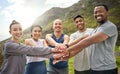 Staying fit and enjoying the journey together. Portrait of a group of sporty young people joining their hands together Royalty Free Stock Photo