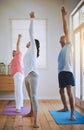 Staying healthy in their golden years. a teacher taking two seniors through a yoga class. Royalty Free Stock Photo