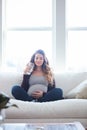 Staying hydrated for baby. Full length shot of an attractive young pregnant woman drinking water while sitting on the Royalty Free Stock Photo