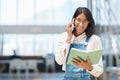 Staying organised in order to achieve more in less time. a young businesswoman talking on a cellphone while going