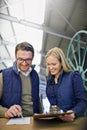 Staying organized in the warehouse. a two managers reading paperwork while standing on the factory floor. Royalty Free Stock Photo