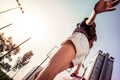 Excited pleasant girl rolling around while walking in park alone