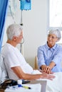 Staying strong by his side. a sick man in a hospital bed being comforted by his wife. Royalty Free Stock Photo