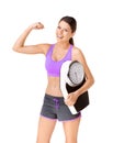Staying strong and keeping fit. Studio portrait of a happy young woman flexing one arm and carrying a scale isolated on