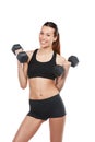 Staying strong. Studio shot of a young woman working out with dumbbells against a white background.
