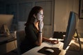 Staying true and dedicated to the job. a businesswoman working late on a computer in an office.