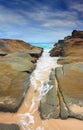 Steadfast, Sea wash through rock crevice Royalty Free Stock Photo