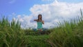 Steadicam shot of a young woman doing meditation for Muladhara chakra in a Balinese way