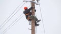 With a steady gaze, he repairs live wires with utmost precision.