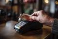 With a steady hand, an elderly gentleman employs a card for his contactless purchases. Royalty Free Stock Photo