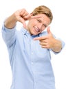 Steady now. a handsome young businessman standing alone in the studio and using his fingers to frame his face.