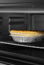 Steak and ale pie cooked in an electric oven grill in foil dish. Royalty Free Stock Photo