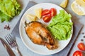 Steak baked salmon fish on a plate with fresh vegetables