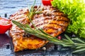 Steak chicken breast olive oil cherry tomatoes pepper and rosemary herbs. Royalty Free Stock Photo