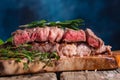 Steak cooked in Rare, marbled beef. With rosemary on a kitchen wood background. Cooking meat, cooking recipes, recipe book