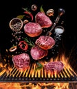 Steak cooking. Conceptual picture. Steak with spices and cutlery under burning grill grate Royalty Free Stock Photo