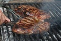 Steak cooking on flame grill Royalty Free Stock Photo