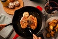 Steak dinner preparation.Female hands serving and decorating a special occasion gourmet meal. Filet mignon and baked potatoes with Royalty Free Stock Photo