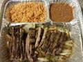 Steak fajita meat with rice and beans in metal container