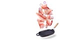 A steak of flying fish falls into the pan. The effect of flying motion in the cooking process.Isolated objects on a white Royalty Free Stock Photo