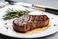 Steak, fork and knife, rosemary and garlic Royalty Free Stock Photo